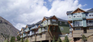 colorado mountain style townhouses with rustic timber beams with mountain background was built by one of Ascent's clients