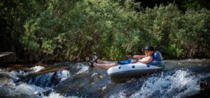 Team member tubing down river